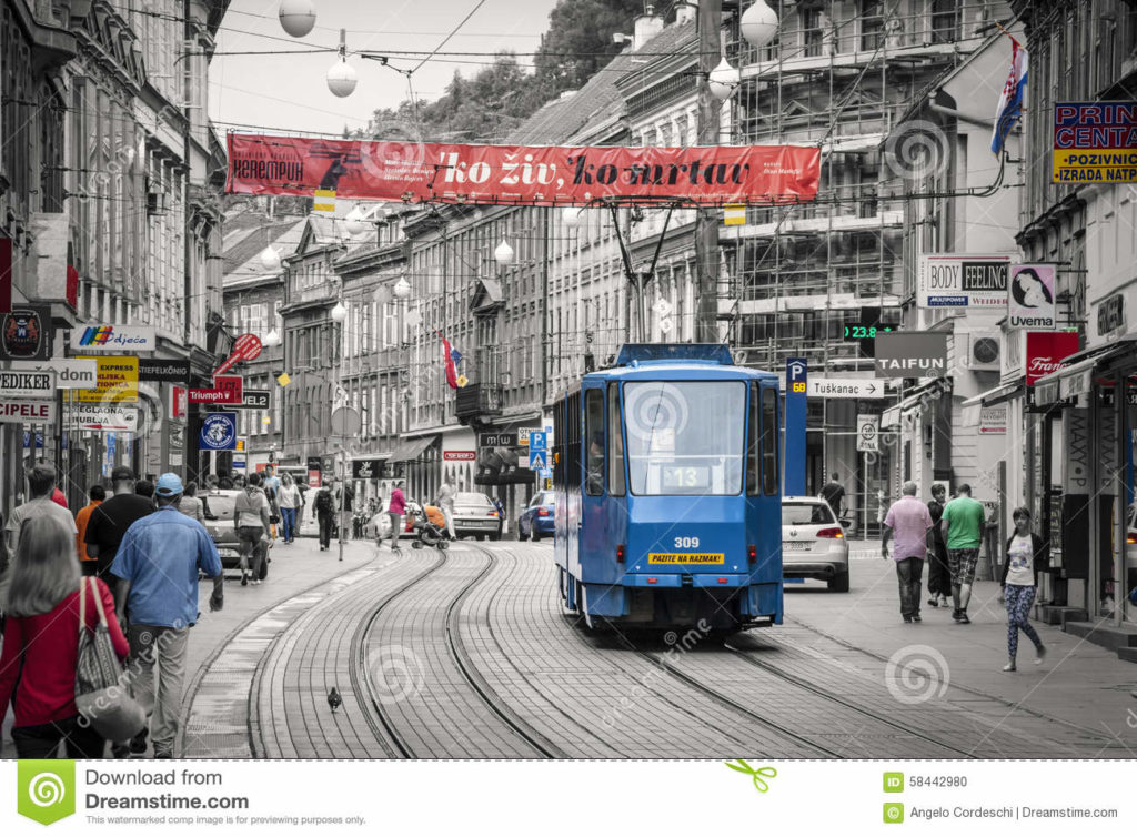 Zagreb, Croatia. Tram in the historic center of the city with the population and tourists. Black and white with colored details.