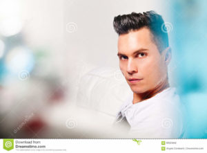 Beautiful model, handsome man portrait. Hairstyle modern look Close portrait of a young man with stylish hair. Lights, colors, bokeh. Beautiful face and serene expression. Intense look.