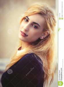 Sweet young blonde girl. Youthful fine beauty. Emotional pose Portrait of a beautiful young Italian girl. Bright eyes and soft colors. Love and romance concept.