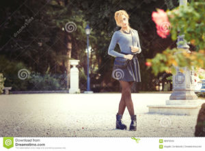 Teen love. Romantic girl outdoor A young blonde young girl outdoors in a park. Romantic scene. Outdoor fashion.