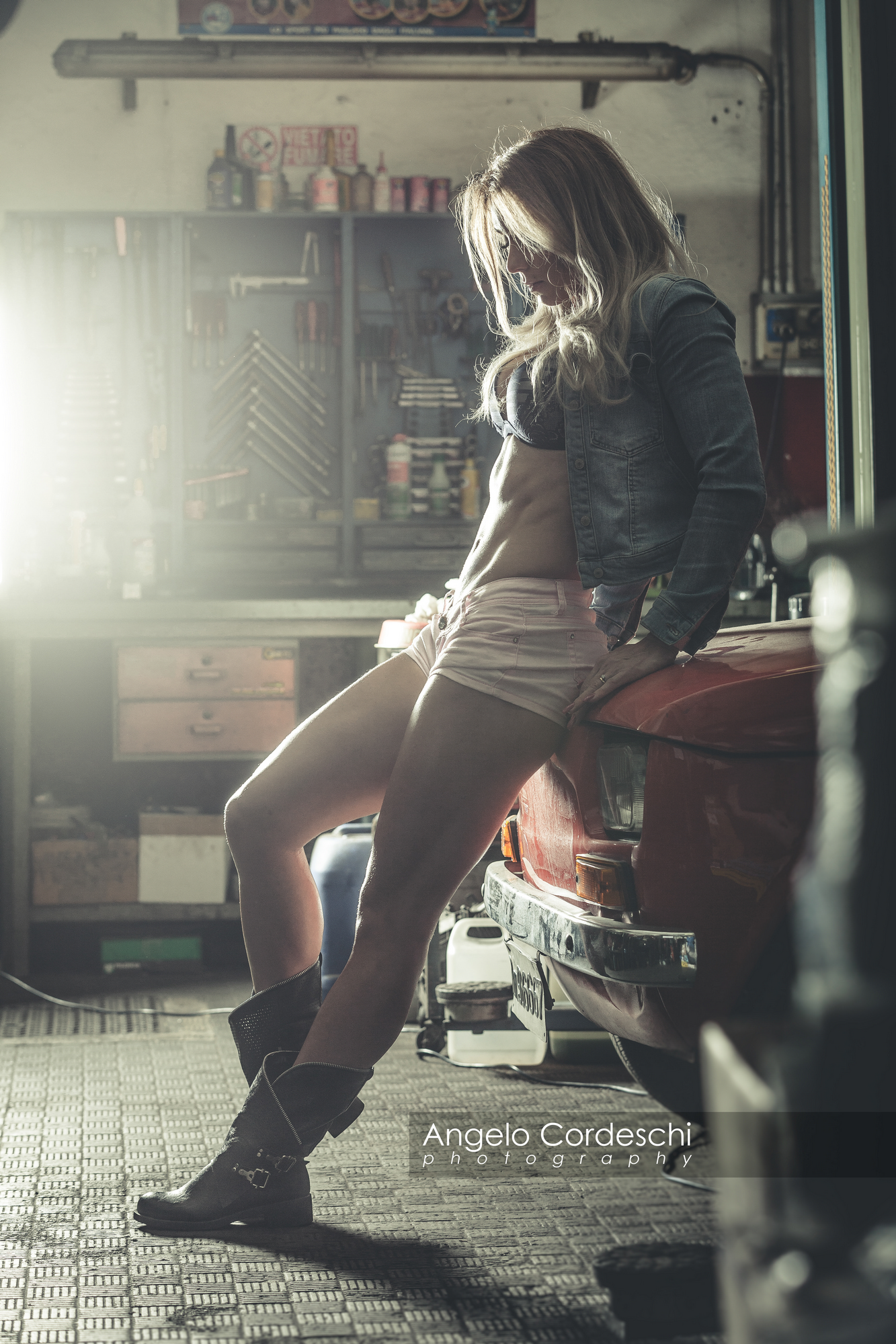 Sensual And Sexy Woman In Front Garage Sitting On An Old Vintage