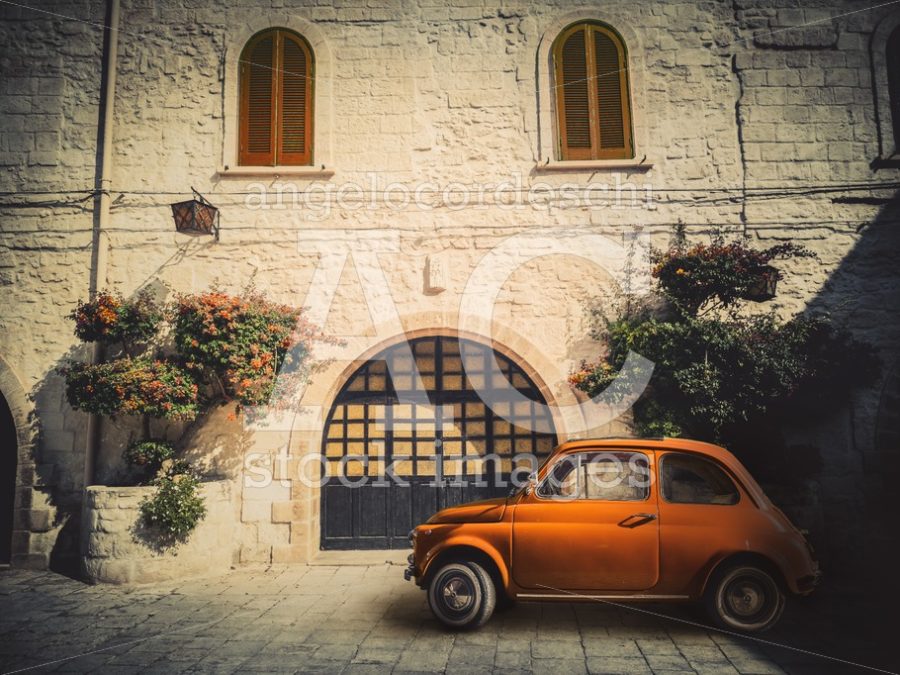 Antique Small Orange Italian Car, Parked On The Road In Front Of Angelo Cordeschi