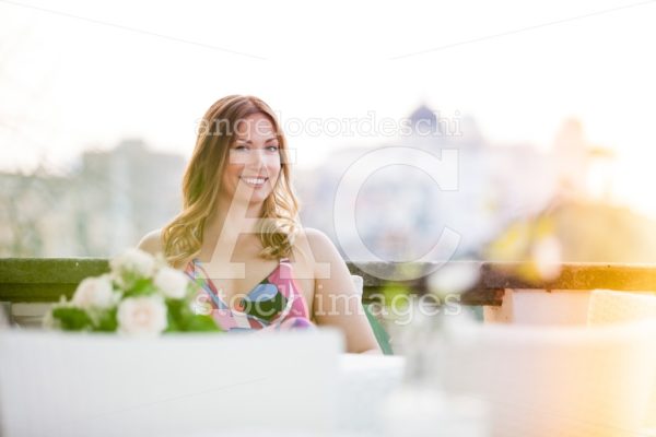 Beautiful Smiling Woman Sitting At The Restaurant. Angelo Cordeschi