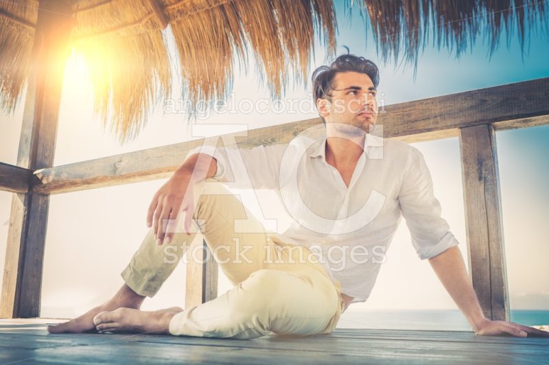 Beautiful Young Relaxed Man In A Small Wooden Deck. Sun Backligh Angelo Cordeschi