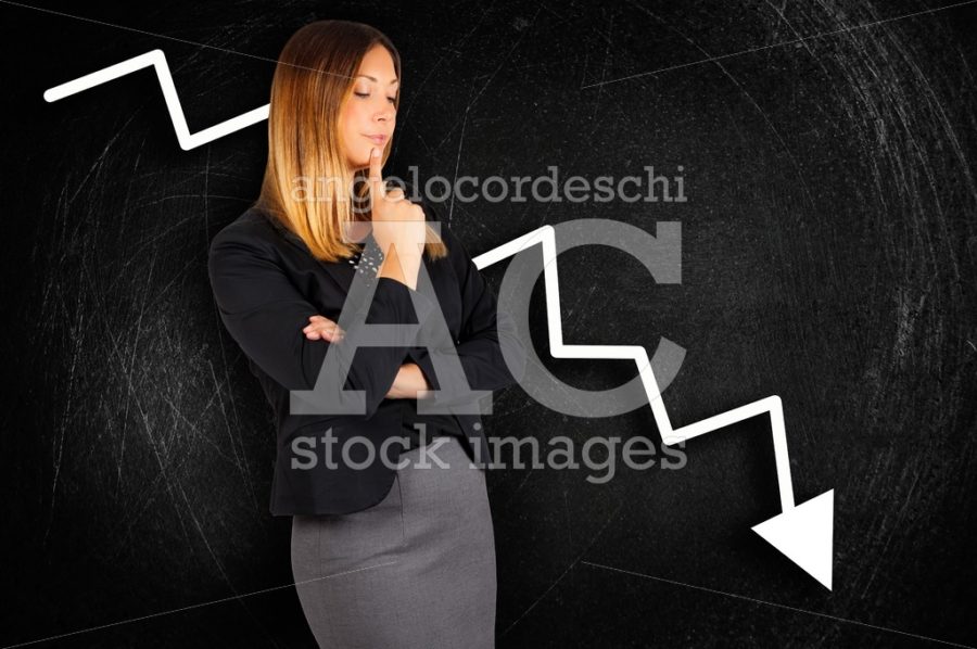 Business woman worried with chart loss behind on chalkboard. - Angelo Cordeschi