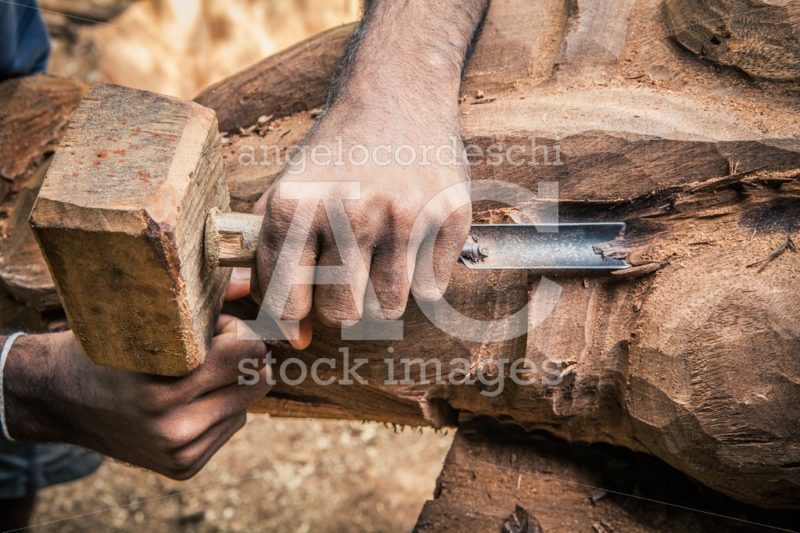 Carpenter working wood. Rudimentary tools. Two hands chiseling a - Angelo Cordeschi