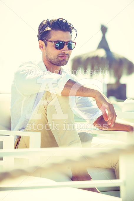 Charming And Attractive Man With Sunglasses Sitting And Relaxed Angelo Cordeschi