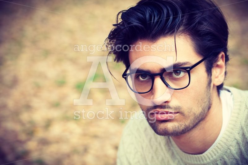 Close portrait of a handsome young man with glasses outdoor. Att - Angelo Cordeschi