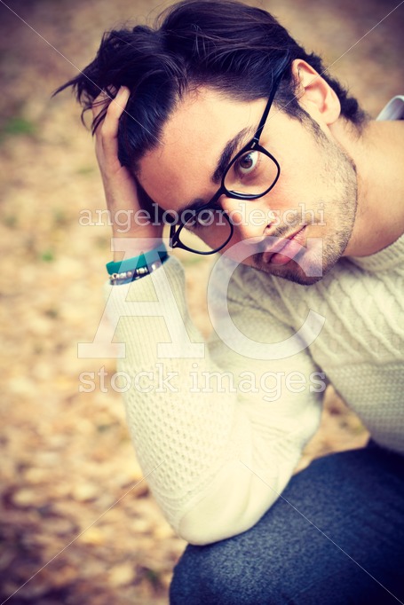 Close portrait of a handsome young man with glasses outdoor. Att - Angelo Cordeschi