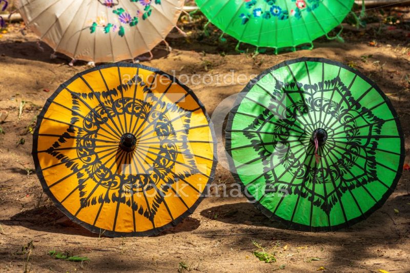 Colored traditional asian umbrellas on the ground on sale. - Angelo Cordeschi
