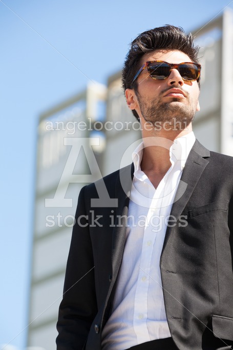 Confident  business handsome man with sunglasses standing outdoor. - Angelo Cordeschi