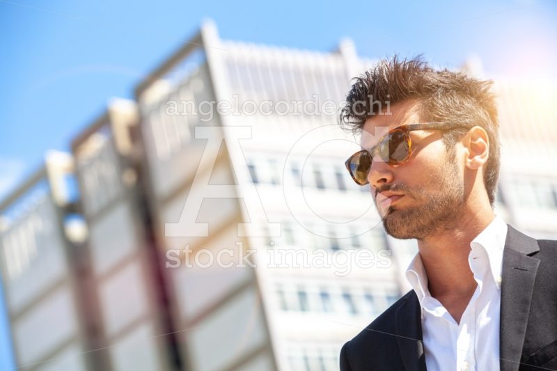 Confident Handsome Man With Sunglasses Outdoor, Building Behind. Angelo Cordeschi