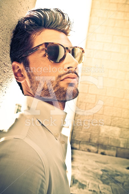 Cool And Handsome Man With Sunglasses Outdoor. Leaning To A Wall Angelo Cordeschi
