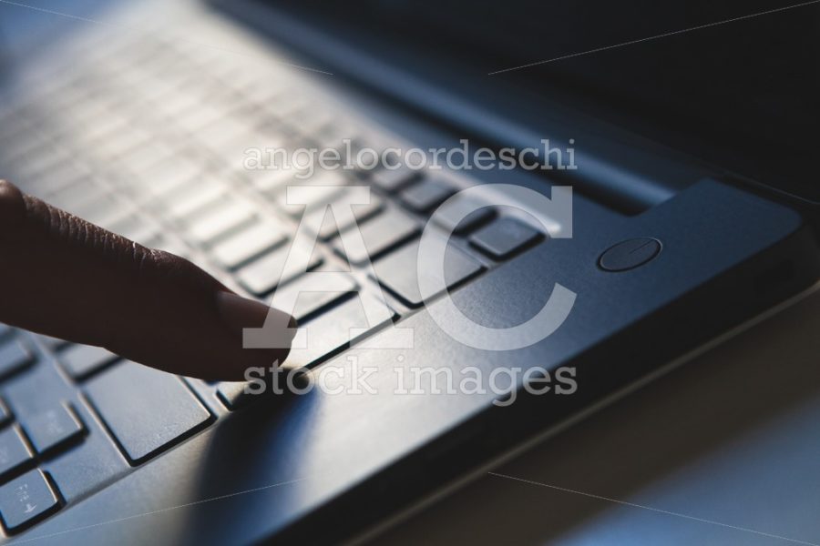Finger Pressing The Enter Key On The Laptop Angelo Cordeschi