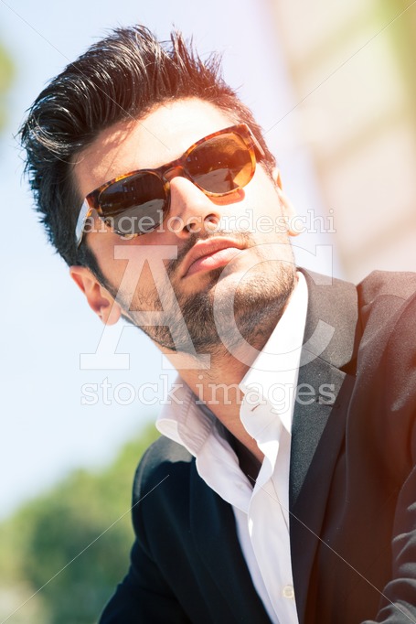 Gorgeous stylish man with sunglasses. Stubble and blacks hair. - Angelo Cordeschi