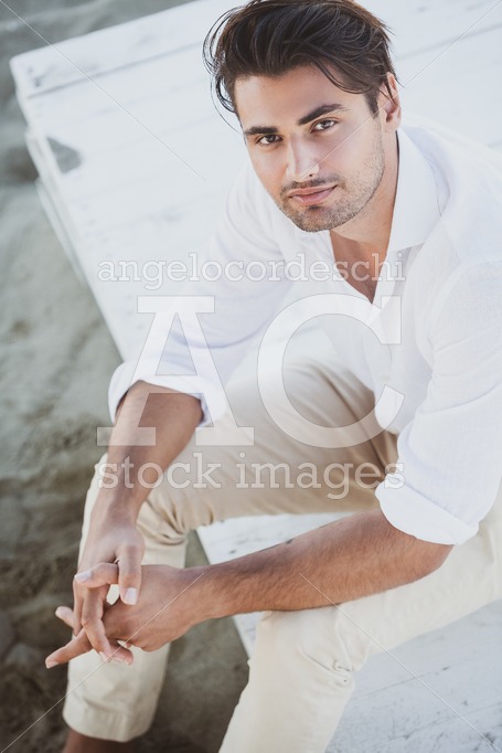 Handsome And Relaxed Young Man Sitting Looking Up. Angelo Cordeschi