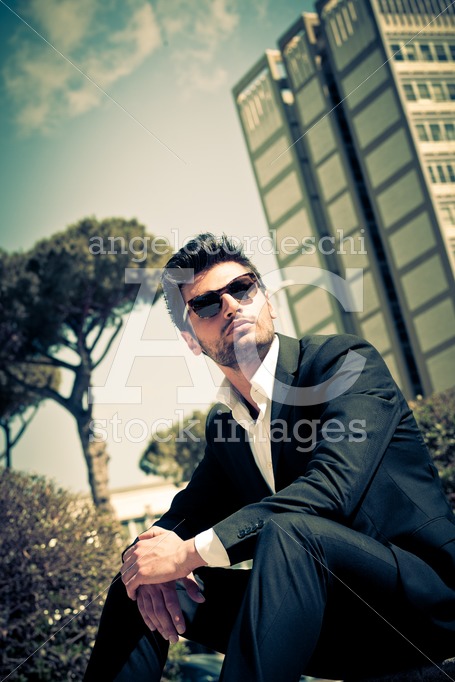 Handsome man model sitting watching with sunglasses. Career. - Angelo Cordeschi