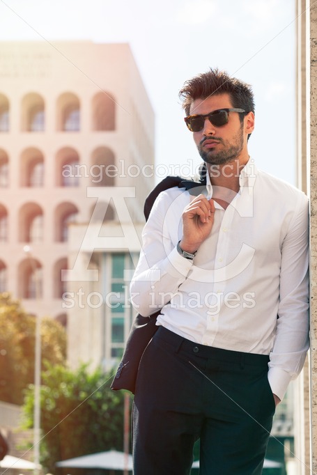 Handsome young Italian man outdoors, wearing sunglasses and shirt. - Angelo Cordeschi
