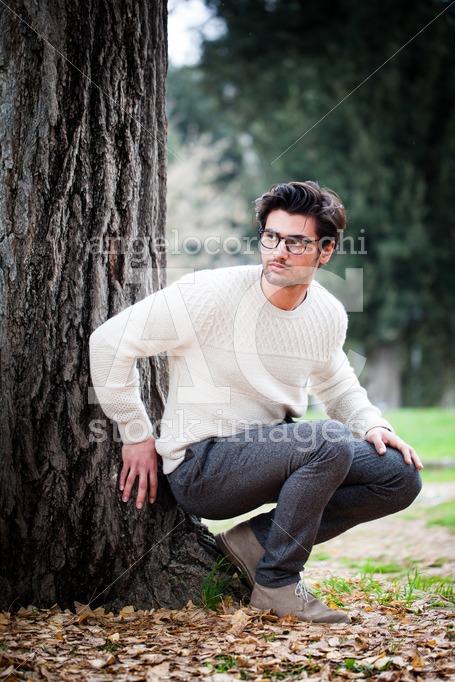 Handsome young man alone in nature near a tree outdoors. A charm - Angelo Cordeschi