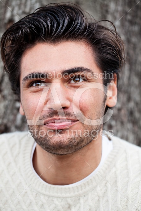 Handsome young man laughing outdoor. Stylish hairstyle, stubble. - Angelo Cordeschi