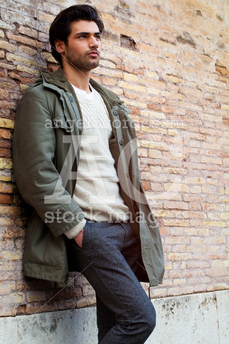 Handsome Young Man Leaning On A Wall Outdoors. Casual Clothes, W Angelo Cordeschi