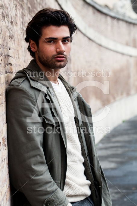 Handsome Young Man Leaning On A Wall Outdoors. Casual Clothes, W Angelo Cordeschi
