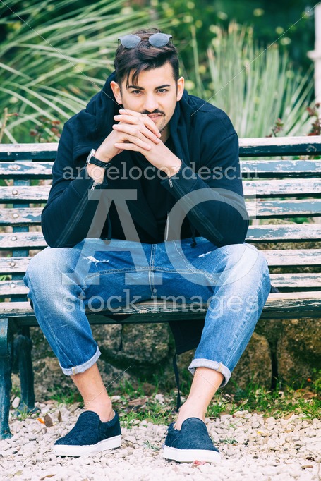 Handsome Young Man Model Sitting On The Bench. A Handsome Young Angelo Cordeschi