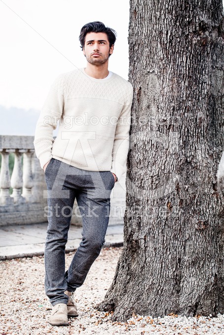 Handsome Young Man Outdoor Leaning On A Tree Trunk With Hands In Angelo Cordeschi