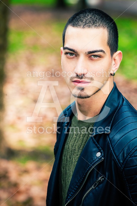 Handsome Young Man Outdoors, Short Hair Style. Wearing A Leather Angelo Cordeschi
