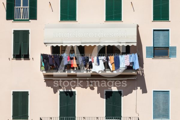 House Facade With Clothes Hanging Out To Dry. Italian Culture. Angelo Cordeschi