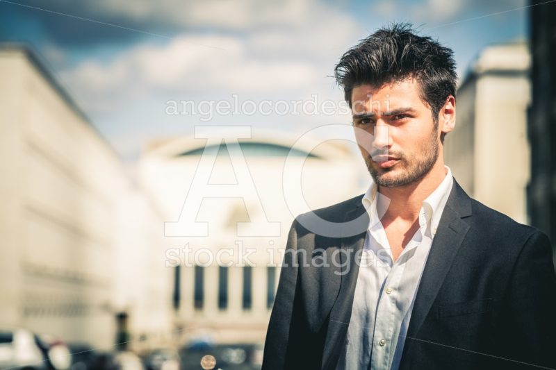 Man in suit and white shirt looking. With fashionable hair and beard. - Angelo Cordeschi