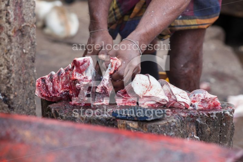 Man With Knife Chopping Raw Fish In A Open Market. Negombo, Sri Angelo Cordeschi