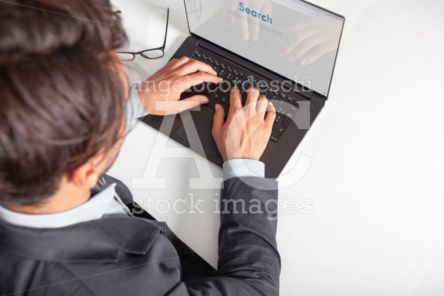 Man With Laptop Typing On The Keyboard Doing A Search Angelo Cordeschi