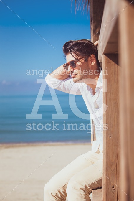 Man With White Shirt And Sunglasses On Beach Vacation Looking Angelo Cordeschi