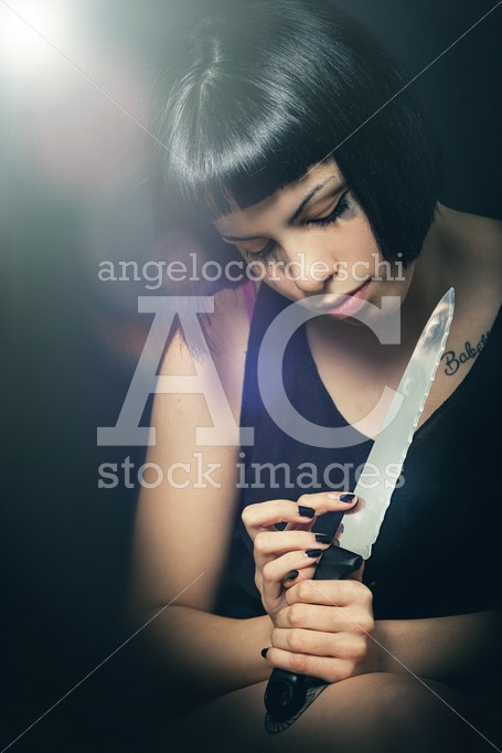 Murderous Suicide Girl With Knife. Crime Concept. A Beautiful Gi Angelo Cordeschi