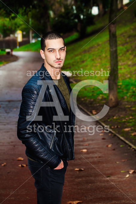Portrait Of A Beautiful Young Boy Outdoors In A Park. Trees And Angelo Cordeschi
