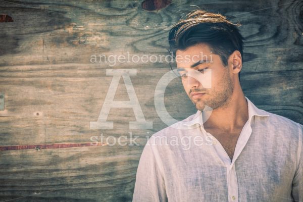 Profile Portrait Of Thoughtful And Handsome Man On Wooden Backgr Angelo Cordeschi