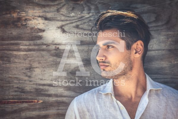 Profile Portrait Of Young And Handsome Man On Wooden Background. Angelo Cordeschi