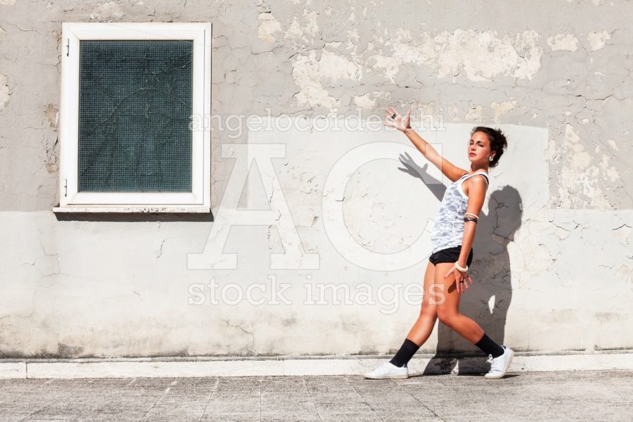 Seductive young woman with shorts and tank top posing like a dan - Angelo Cordeschi