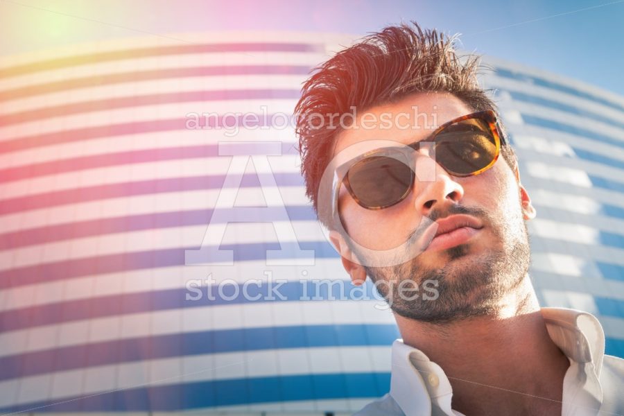 Sexy Young Modern Man. Sunglasses, City Building. Hairstyle. Beh Angelo Cordeschi
