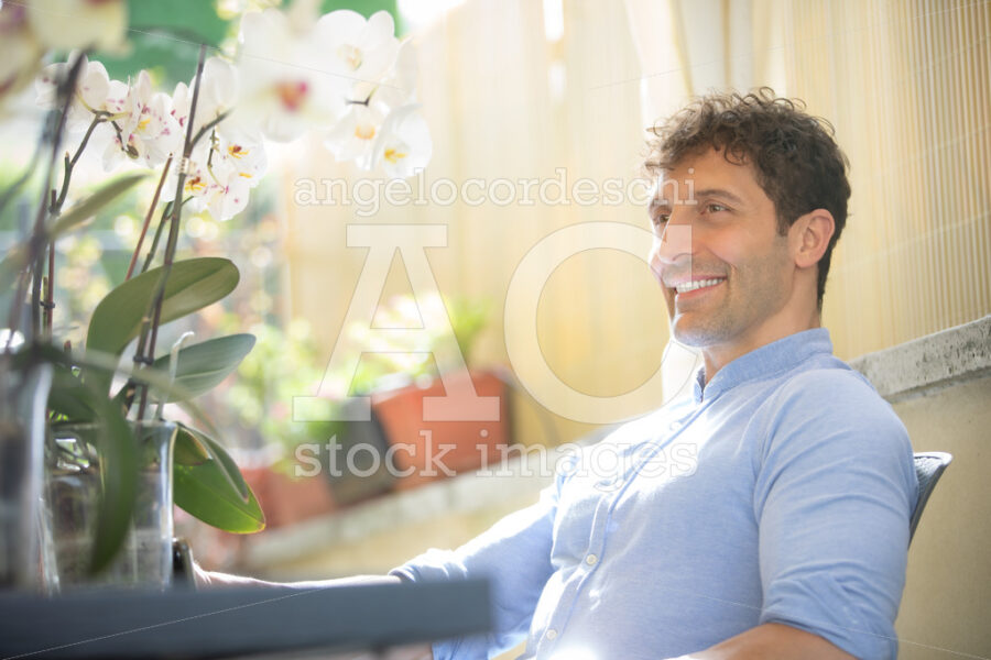 Smiling And Positive Man Sitting Outdoors. White Caucasian With Angelo Cordeschi