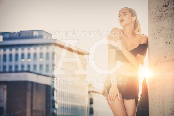 Stylish Woman With Urban Sunset Behind. Casual Clothes, Blonde H Angelo Cordeschi