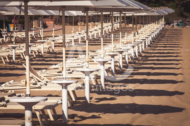 Sunbed And Umbrellas Repetition At The Beach. Italian Coast With Angelo Cordeschi