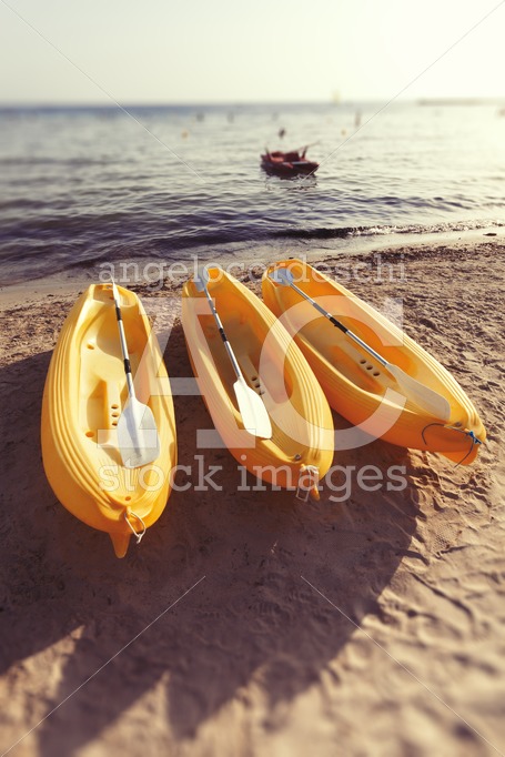 Three Yellow Canoes Are On The Beach. In The Background The Medi Angelo Cordeschi
