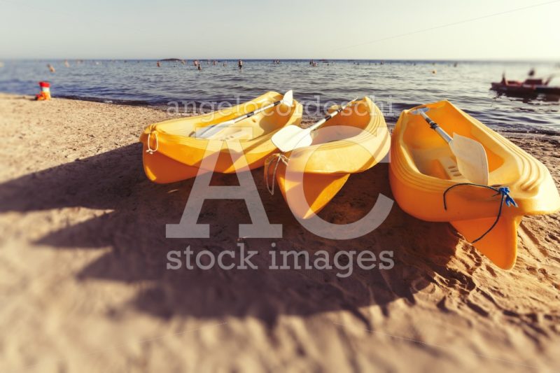 Three Yellow Canoes Are On The Beach. In The Background The Medi Angelo Cordeschi