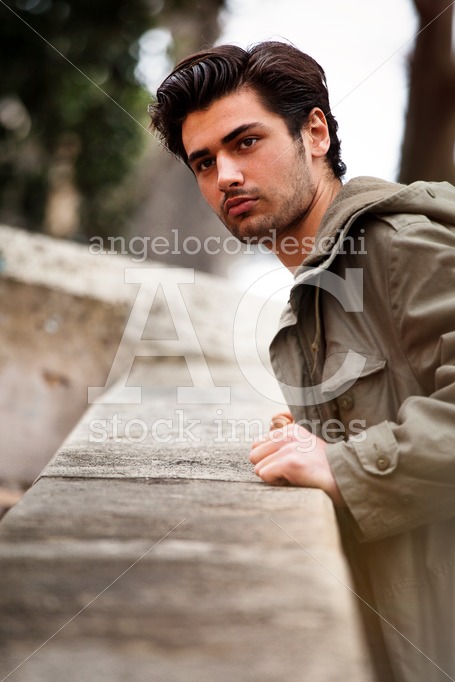 Trendy Young Man Posing Outdoor In The Street Overlooking Leanin Angelo Cordeschi
