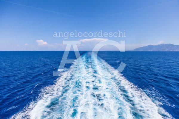 Wake Of Water From A Boat, Open Sea With Horizon And Blue Sky. W Angelo Cordeschi