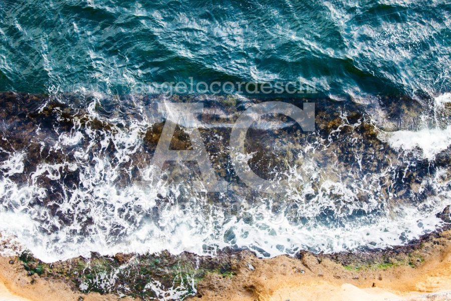 Waves crashing breaking on the rocks. Drone aerial sea surface v - Angelo Cordeschi