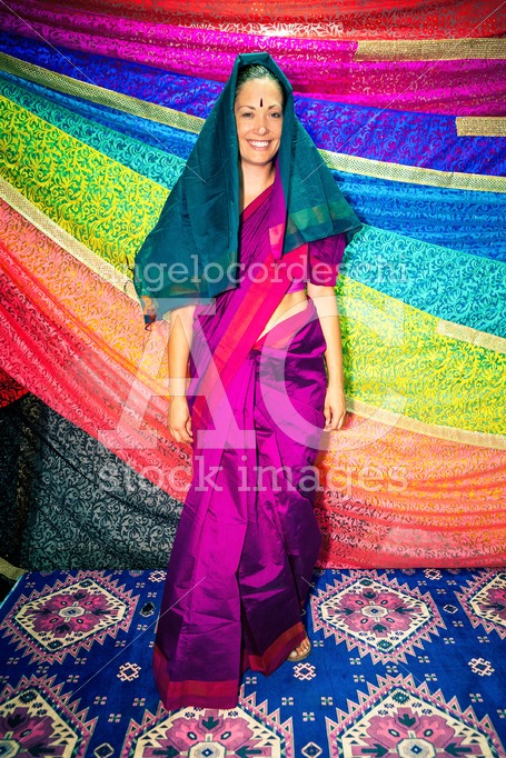 Western woman with Indian clothes. Sari. Background with bright - Angelo Cordeschi