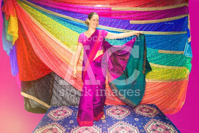 Western woman with Indian clothes. Sari. Background with bright - Angelo Cordeschi